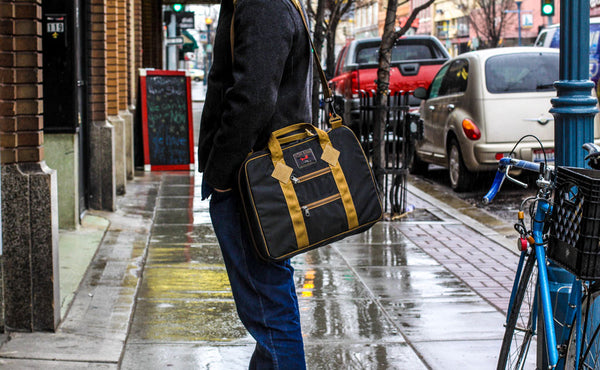 A person in profile wearing the Founder's Briefcase